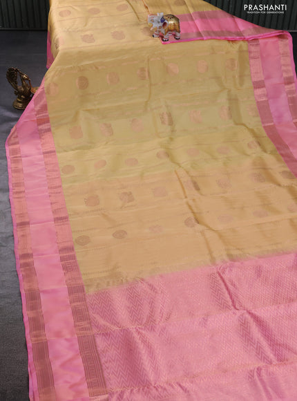 Kanchipuram silk saree pale yellow and peach pink with allover copper zari weaves and rettapet copper zari woven border