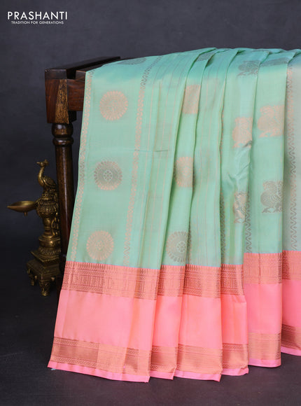 Kanchipuram silk saree pastel green and peach pink with allover copper zari weaves and rettapet copper zari woven border