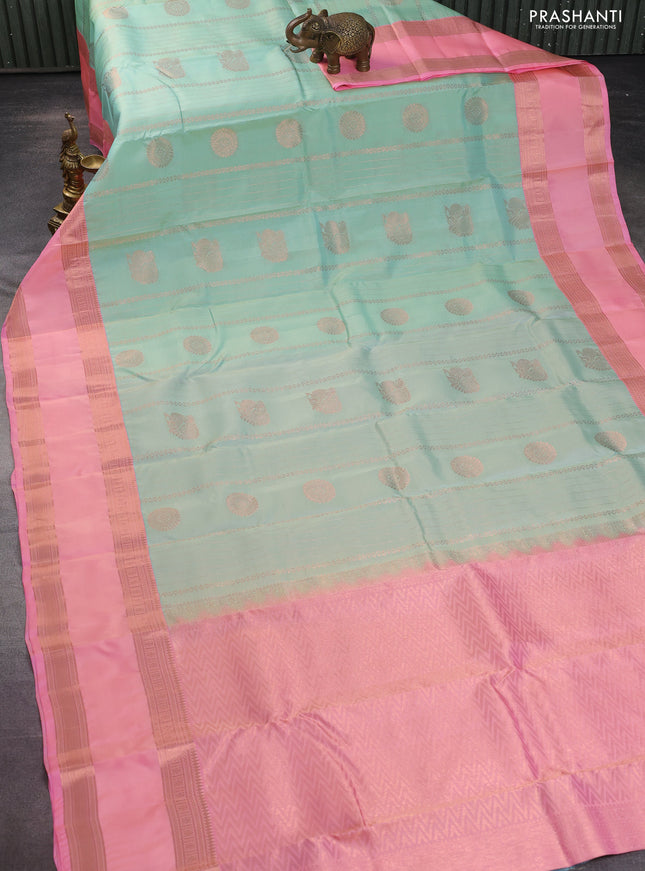 Kanchipuram silk saree pastel green and peach pink with allover copper zari weaves and rettapet copper zari woven border
