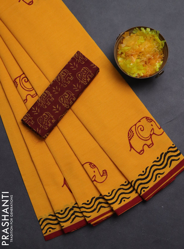 Semi silk cotton saree mango yellow and maroon with elephant butta prints and printed border