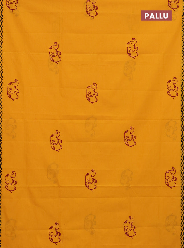 Semi silk cotton saree mango yellow and maroon with elephant butta prints and printed border
