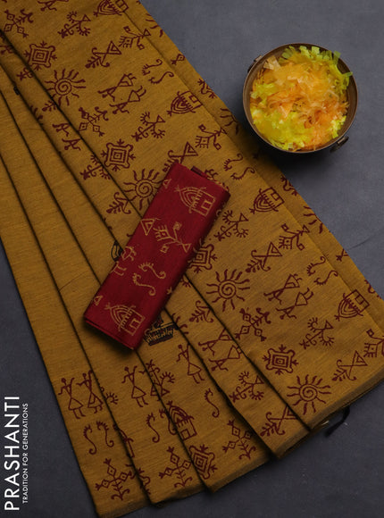 Semi silk cotton saree mustard yellow and maroon with allover warli prints and printed border