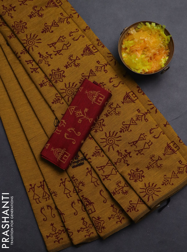 Semi silk cotton saree mustard yellow and maroon with allover warli prints and printed border