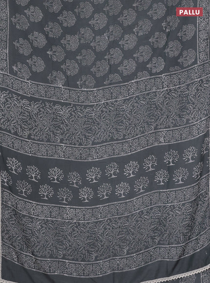 Semi pashmina silk saree grey shade and cream with allover floral butta prints and crocia lace work border