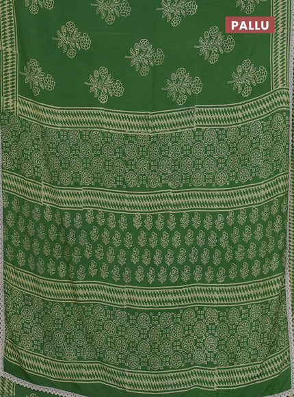 Semi pashmina silk saree green and cream with butta prints and crocia lace work border