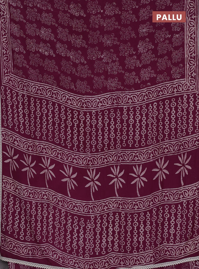 Semi pashmina silk saree wine shade with allover floral butta prints and crocia lace work border