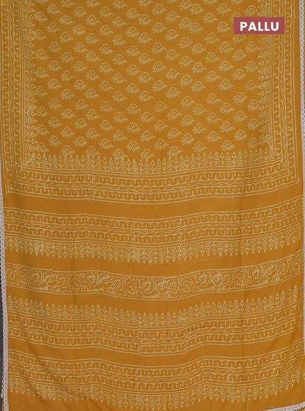 Semi pashmina silk saree mustard yellow and cream with allover butta prints and crocia lace work border