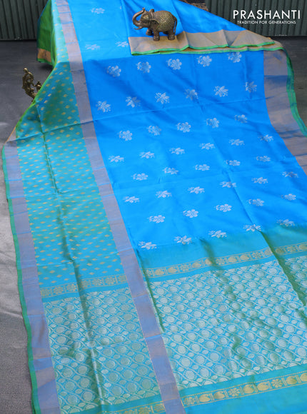 Pure uppada silk saree cs blue and dual shade of teal green with silver zari woven floral buttas and zari woven butta border
