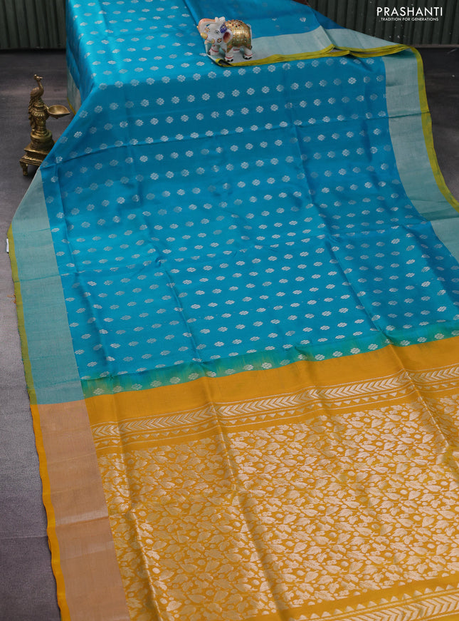 Pure uppada silk saree teal blue and yellow with allover silver zari woven floral buttas and silver zari woven border