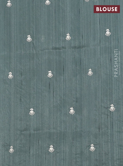 Semi raw silk saree green shade with embroidery work buttas and floral embroidery border