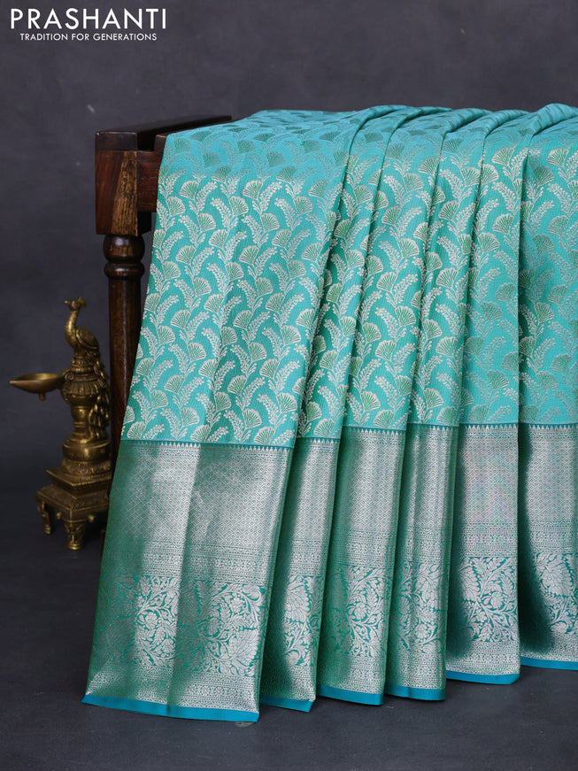 Pure kanchipuram silk saree teal blue and peacock green with allover silver zari woven brocade weaves and long rich zari woven border