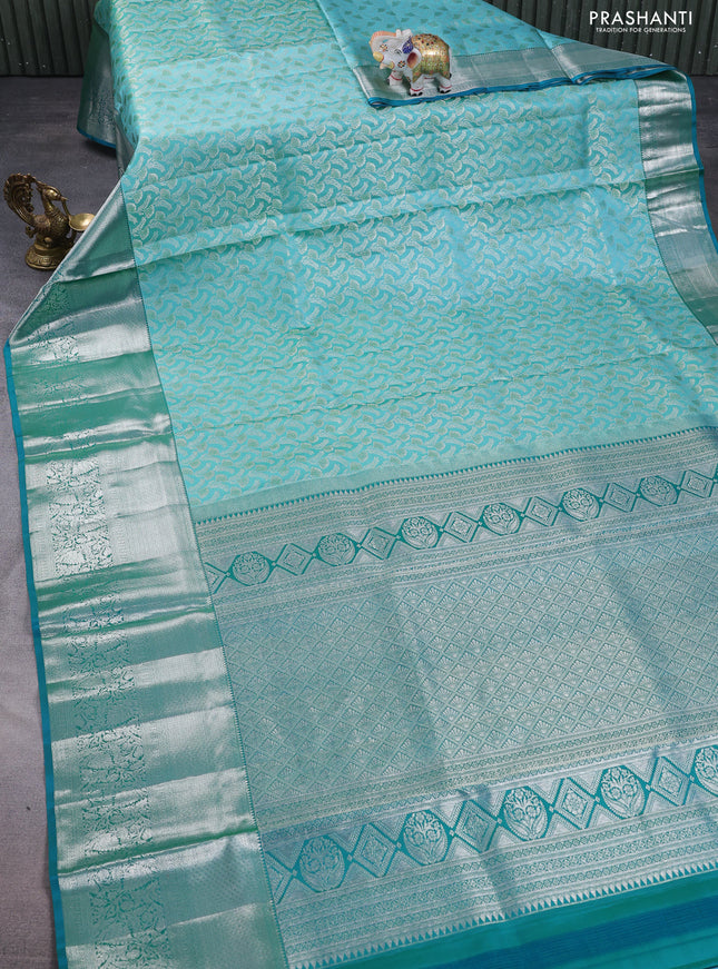 Pure kanchipuram silk saree teal blue and peacock green with allover silver zari woven brocade weaves and long rich zari woven border