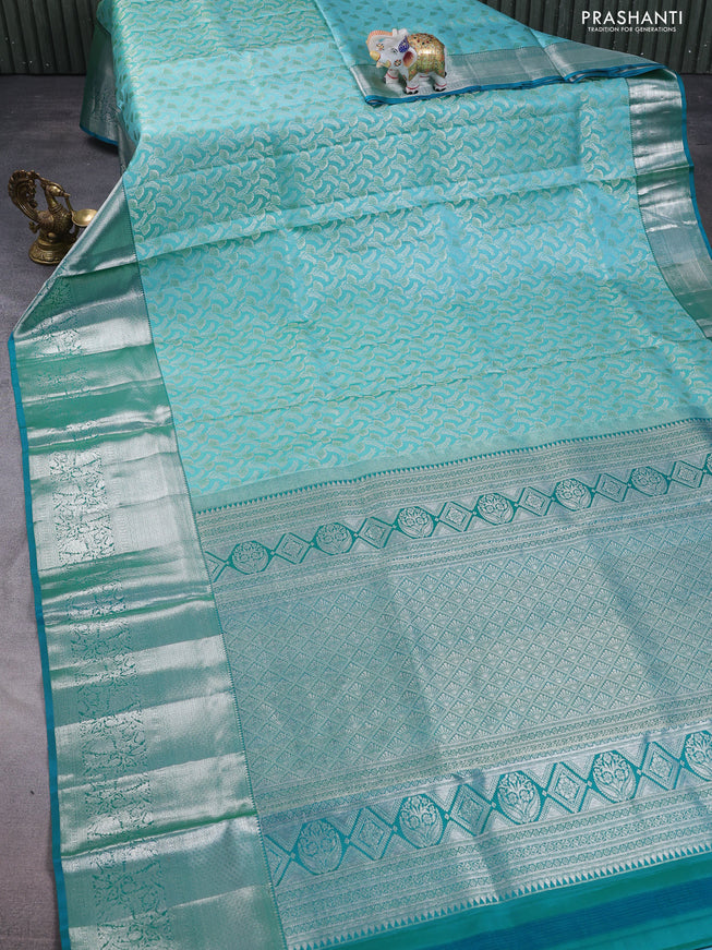 Pure kanchipuram silk saree teal blue and peacock green with allover silver zari woven brocade weaves and long rich zari woven border