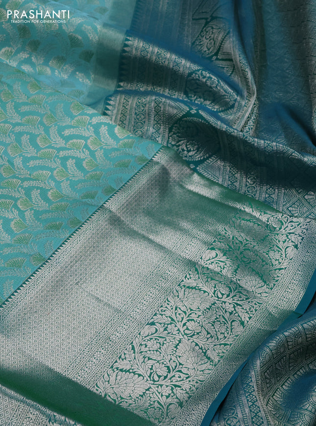 Pure kanchipuram silk saree teal blue and peacock green with allover silver zari woven brocade weaves and long rich zari woven border