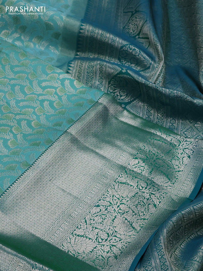 Pure kanchipuram silk saree teal blue and peacock green with allover silver zari woven brocade weaves and long rich zari woven border