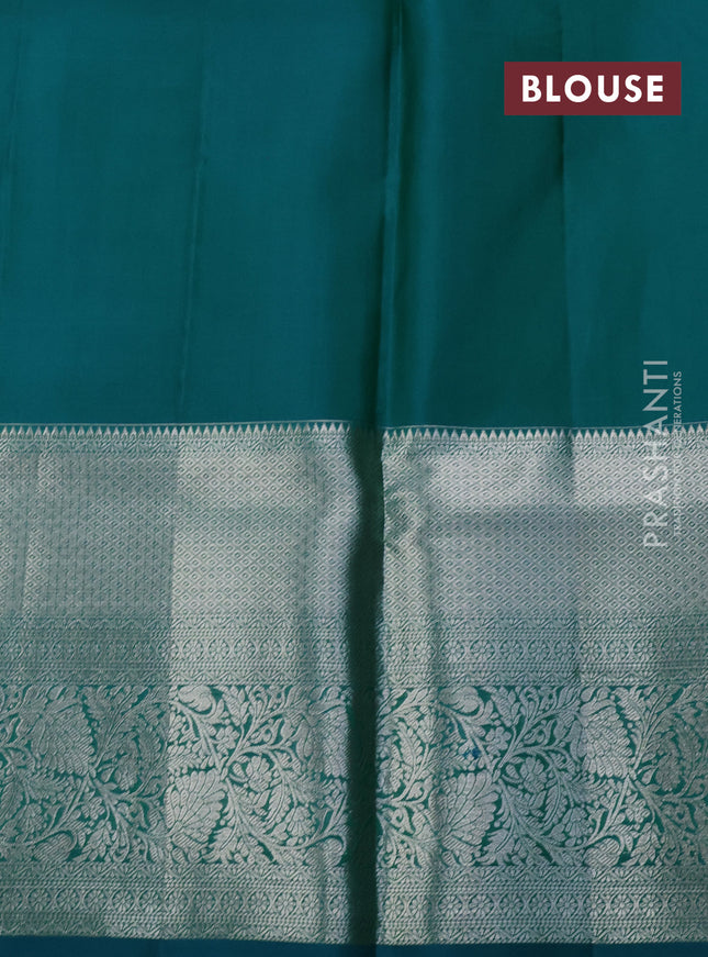 Pure kanchipuram silk saree teal blue and peacock green with allover silver zari woven brocade weaves and long rich zari woven border
