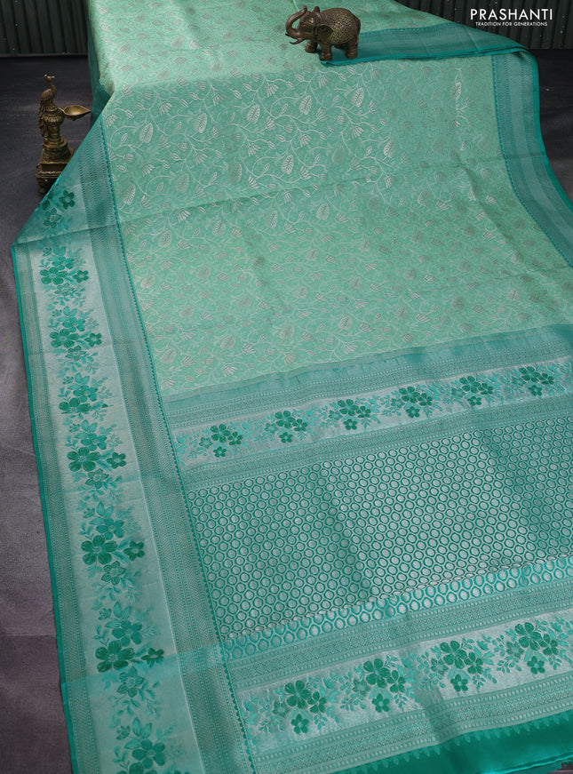 Pure kanchipuram silk saree pastel green and teal green shade with allover silver zari woven brocade weaves and zari woven floral design border