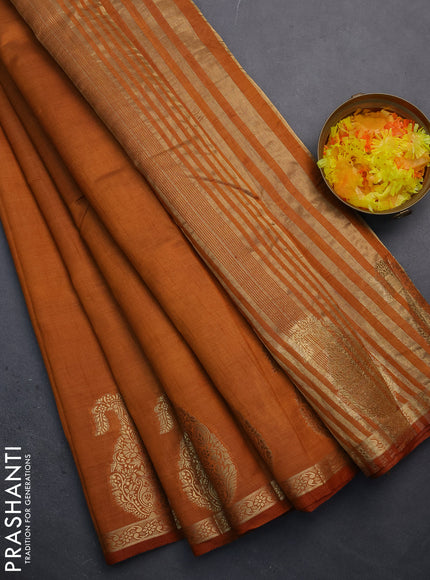 Semi raw silk saree rust shade with plain body and paisley design zari woven butta border
