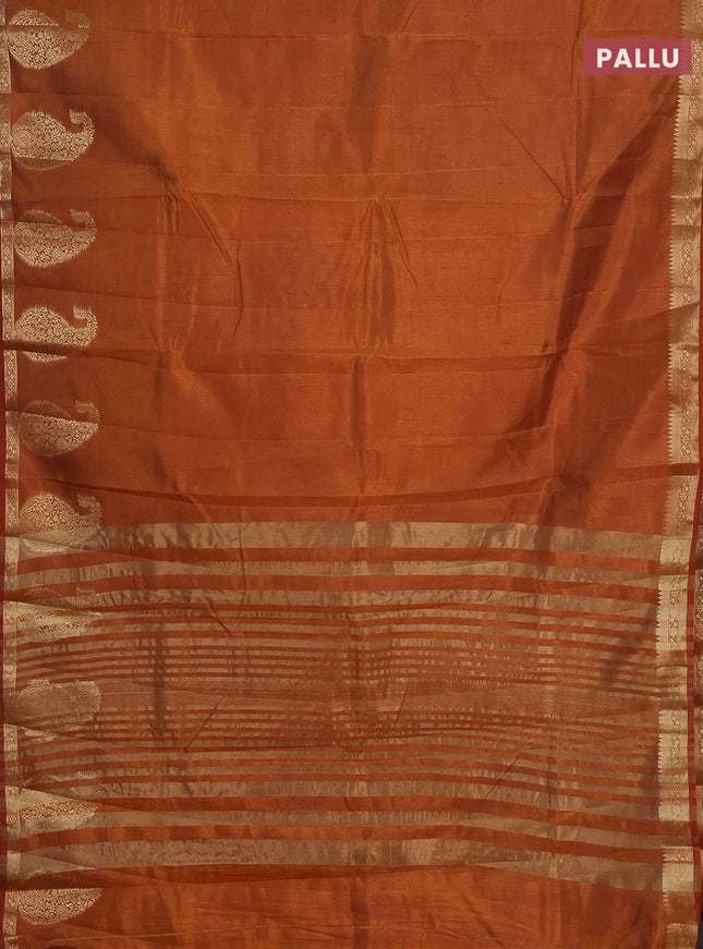 Semi raw silk saree rust shade with plain body and paisley design zari woven butta border