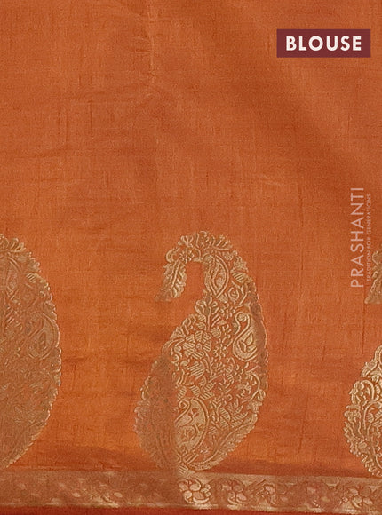 Semi raw silk saree rust shade with plain body and paisley design zari woven butta border