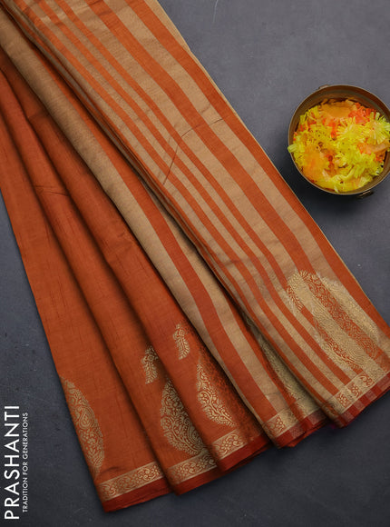 Semi raw silk saree rust shade with plain body and paisley design zari woven butta border