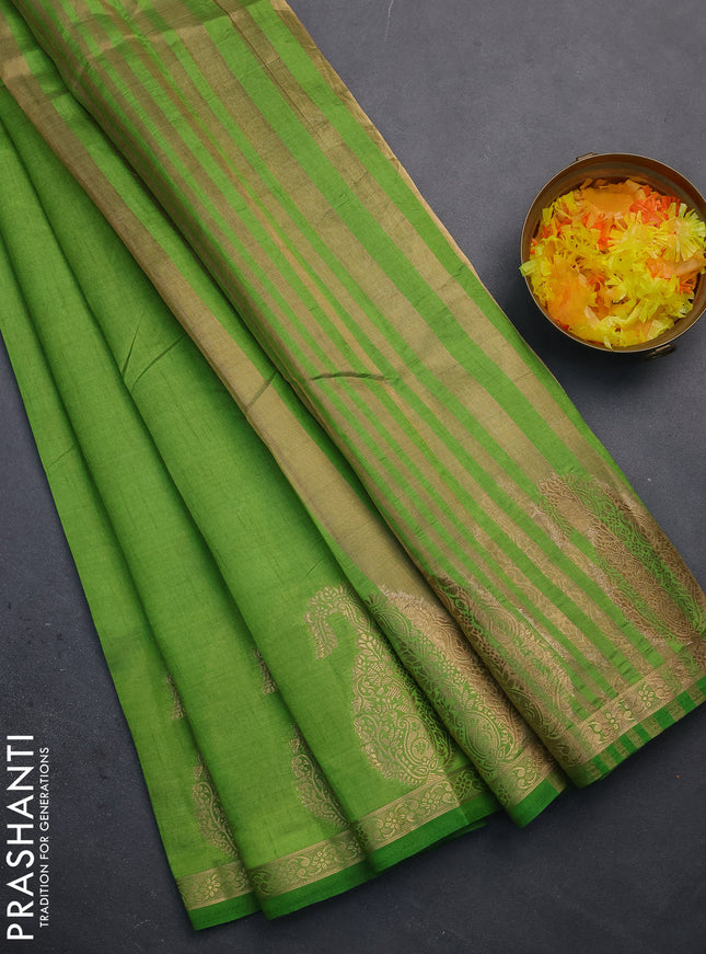 Semi raw silk saree green with plain body and paisley design zari woven butta border