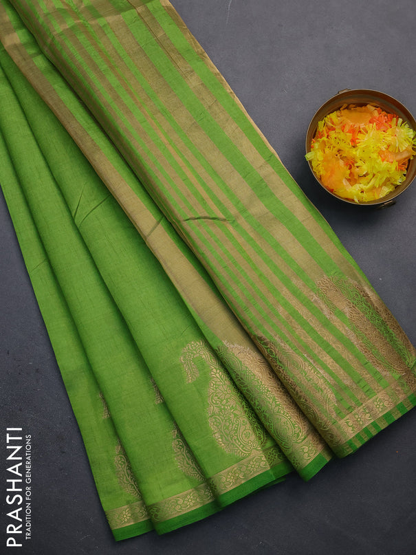 Semi raw silk saree green with plain body and paisley design zari woven butta border