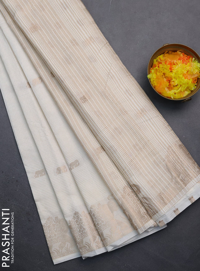 Semi raw silk saree off white with zari weaves & elephant buttas and elephant design zari woven border