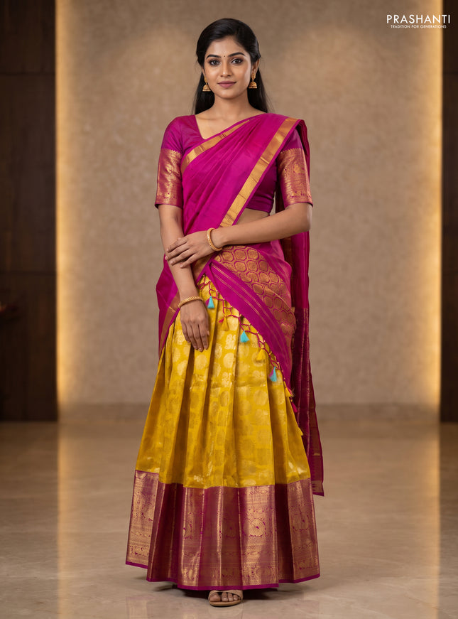 Pure kanchipuram silk lehenga yellow and pink with allover silver zari woven annam mayil chakkaram buttas and long annam zari woven border