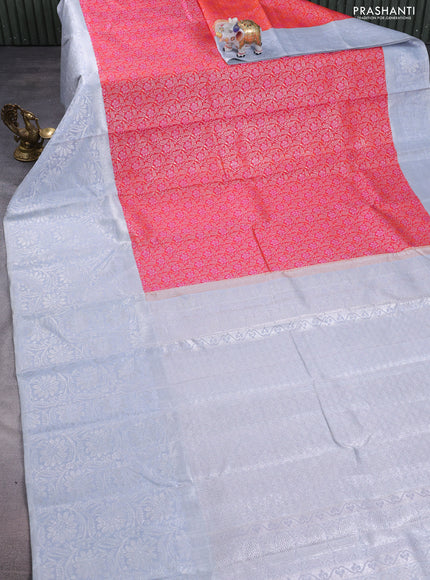 Pure kanchipuram silk saree dual shade of pinkish orange and pastel grey with allover silver zari brocade weaves and long rich silver woven border