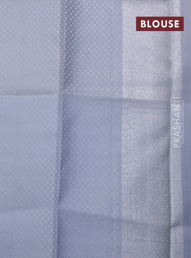 Pure kanchipuram silk saree dual shade of pinkish orange and pastel grey with allover silver zari brocade weaves and long rich silver woven border