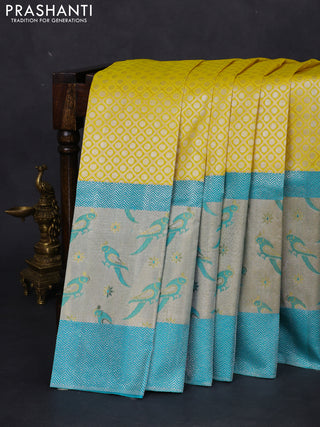 Pure kanchipuram silk saree lime yellow and teal blue with allover silver zari brocade weaves and long rich silver woven border