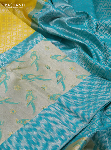 Pure kanchipuram silk saree lime yellow and teal blue with allover silver zari brocade weaves and long rich silver woven border
