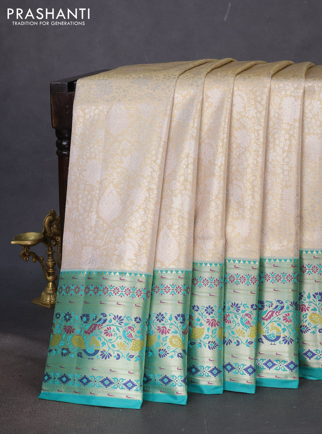 Tissue paithani silk saree sandal and teal green with allover zari woven brocade weaves and zari woven paithani style border