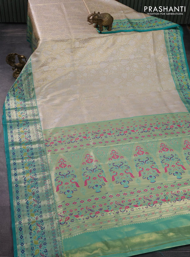 Tissue paithani silk saree sandal and teal green with allover zari woven brocade weaves and zari woven paithani style border