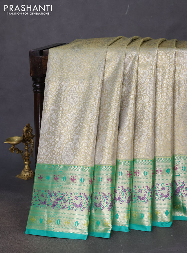 Tissue paithani silk saree dual shade of pastel grey and teal green with allover silver zari woven brocade weaves and zari woven paithani style border