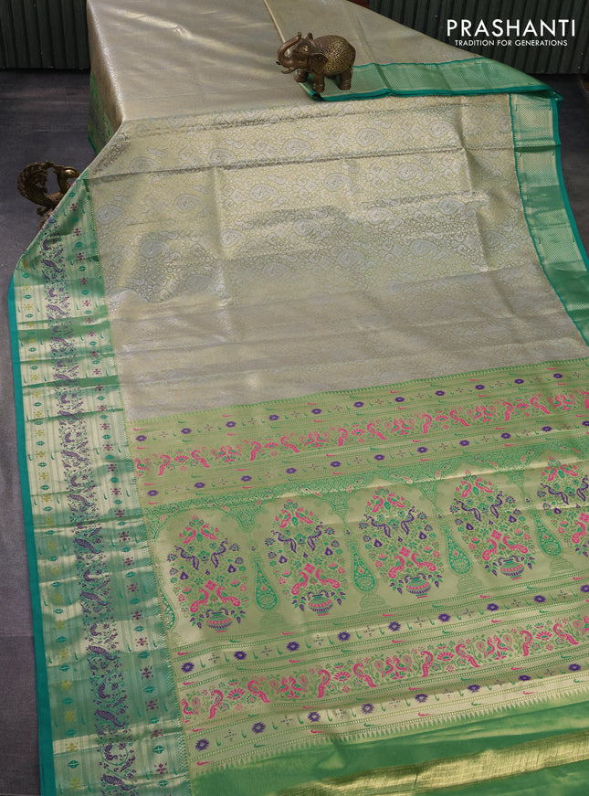 Tissue paithani silk saree dual shade of pastel grey and teal green with allover silver zari woven brocade weaves and zari woven paithani style border