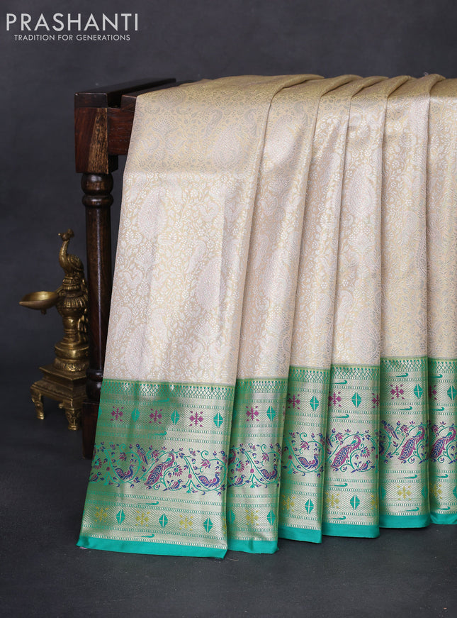 Tissue paithani silk saree cream and teal green with allover silver zari woven brocade weaves and long zari woven paithani style border