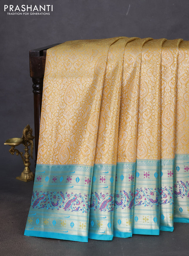 Tissue paithani silk saree mustard yellow and teal green with allover silver zari woven brocade weaves and zari woven paithani style border