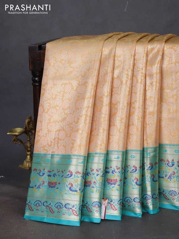 Tissue paithani silk saree dual shade of pale orange and teal blue with allover silver zari woven brocade weaves and zari woven paithani style border