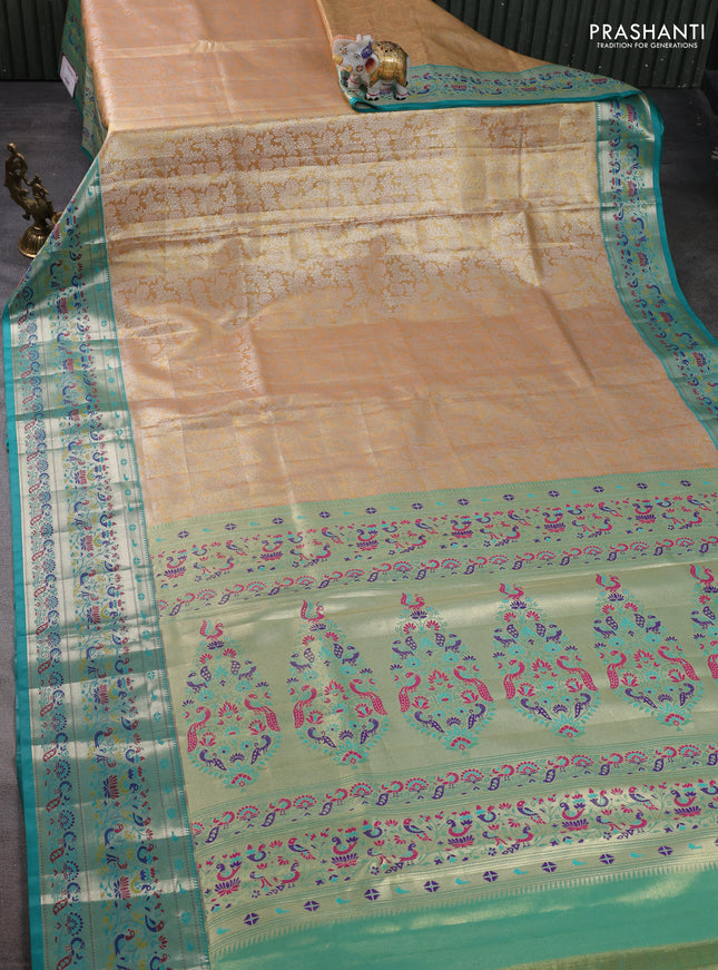 Tissue paithani silk saree dual shade of pale orange and teal blue with allover silver zari woven brocade weaves and zari woven paithani style border