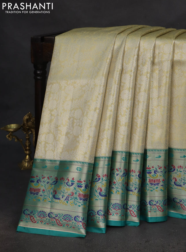 Tissue paithani silk saree cream and teal green with allover silver zari woven brocade weaves and zari woven paithani style border