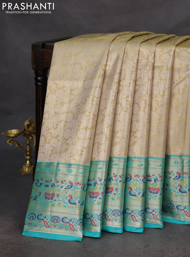 Tissue paithani silk saree cream and teal green with allover silver zari woven brocade weaves and zari woven paithani style border