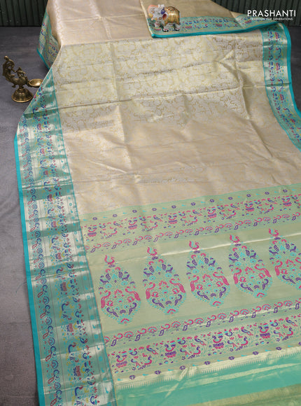 Tissue paithani silk saree cream and teal green with allover silver zari woven brocade weaves and zari woven paithani style border