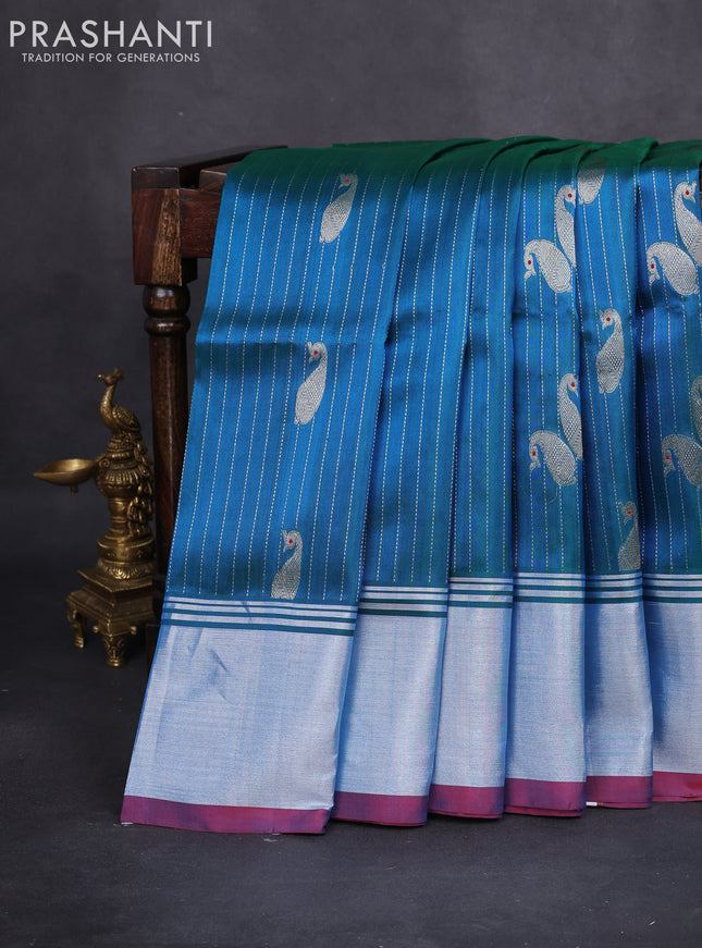 Venkatagiri silk saree dual shade of teal bluish green and red with allover silver zari woven paisley buttas and silver zari woven border