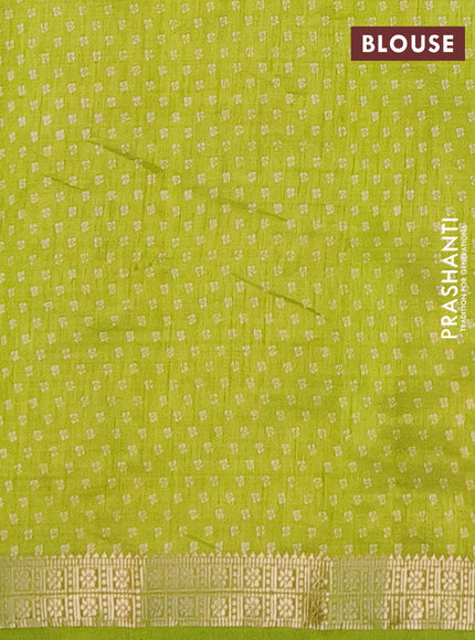 Semi raw silk saree fluorescent green with allover butta prints and zari woven border
