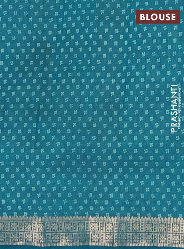 Semi raw silk saree teal blue with allover butta prints and zari woven border