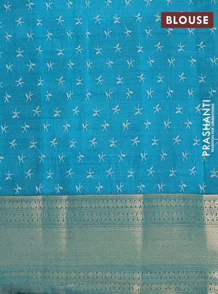 Semi raw silk saree teal blue with allover prints and zari woven border