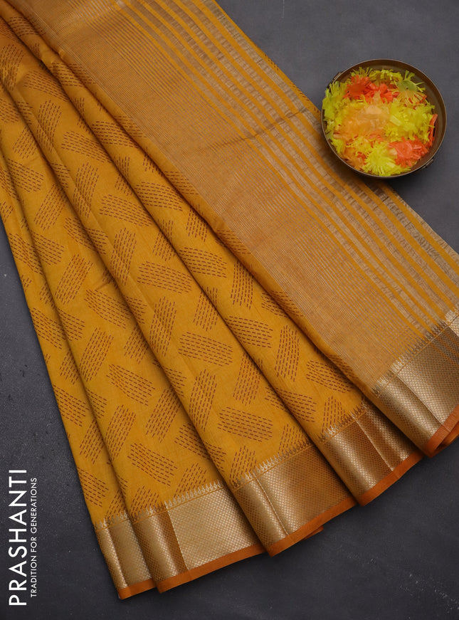 Semi raw silk saree mustard yellow with allover prints and zari woven border