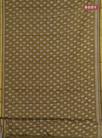 Muslin cotton saree mehendi green with allover dabu prints and zari woven border